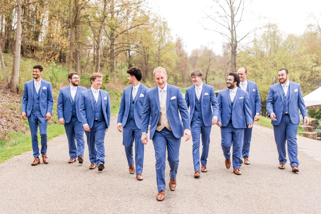 Groom walks with his groomsmen at Rivercrest Farms in Dover, Ohio.