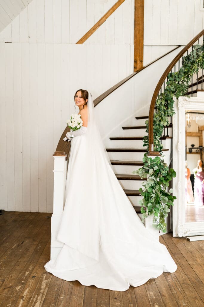 Bride on the staircase at Rivercrest Farms in Dover, Ohio.