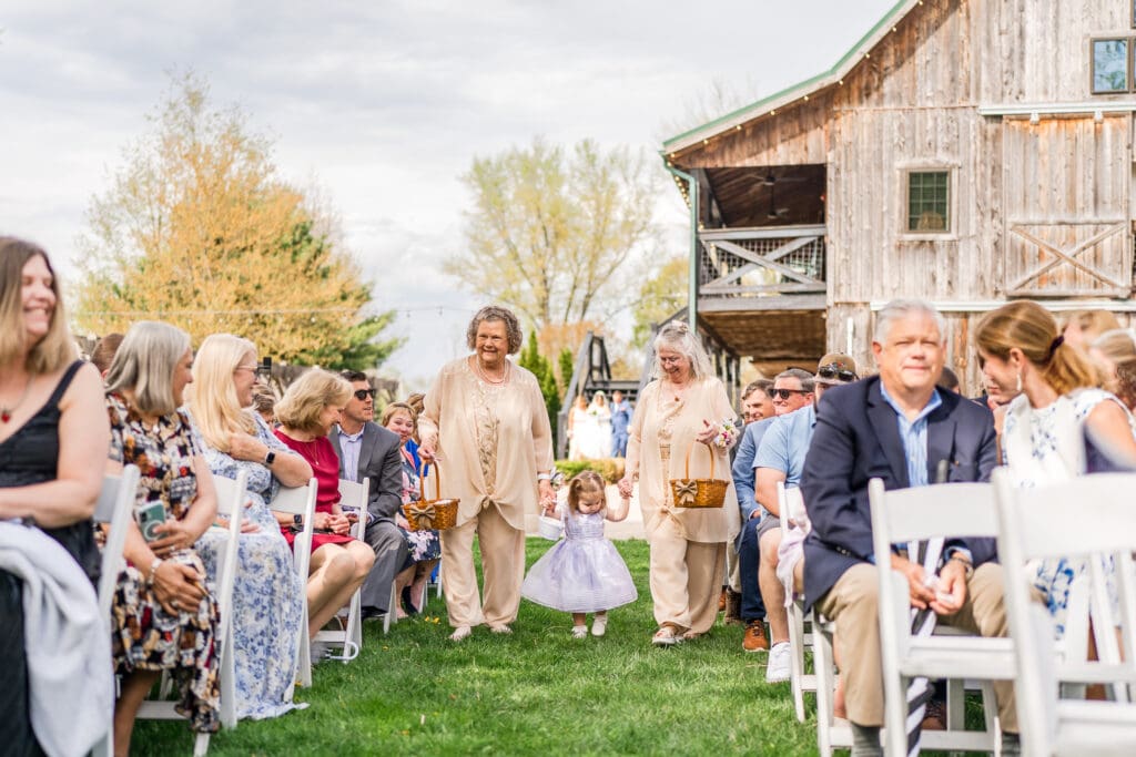 Grandmas and small child perform as flower girls at Rivercrest Farms in Dover, Ohio.