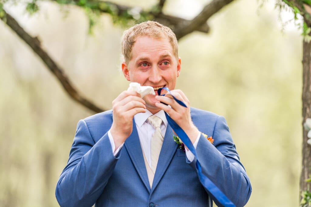 Groom reaction during their wedding at Rivercrest Farms in Dover, Ohio.