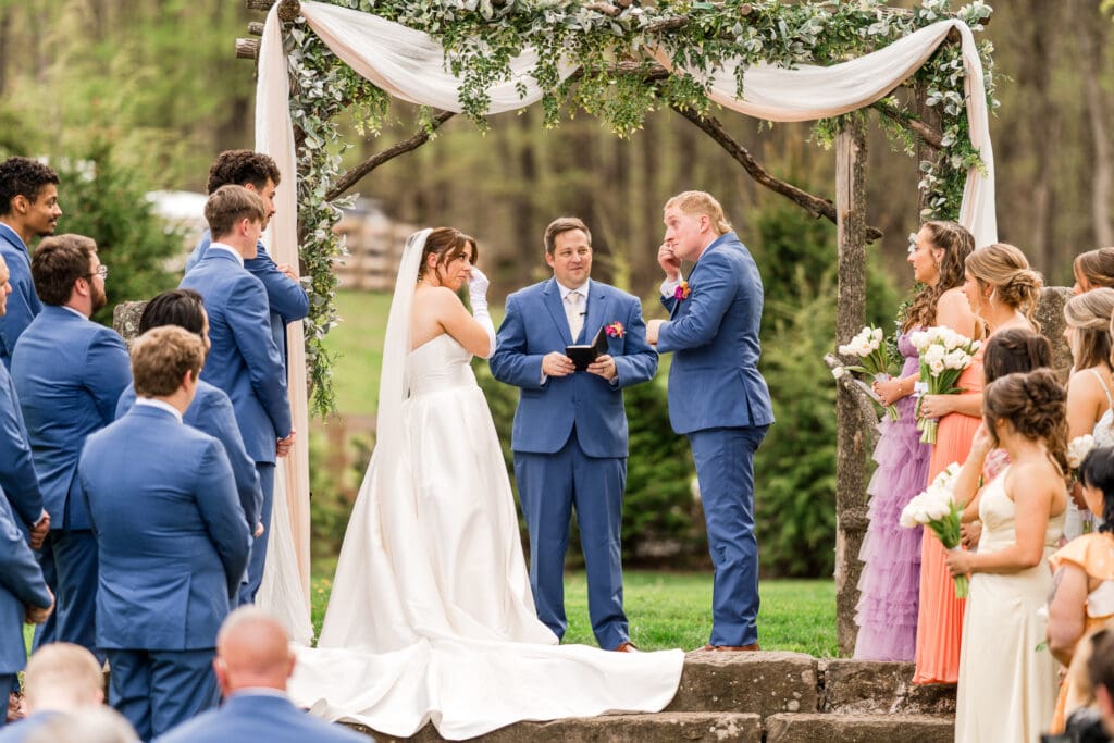 Couple wipes tears away during their ceremony at Rivercrest Farms in Dover, Ohio.
