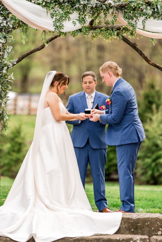 Couple exchange rings at Rivercrest Farms in Dover, Ohio.