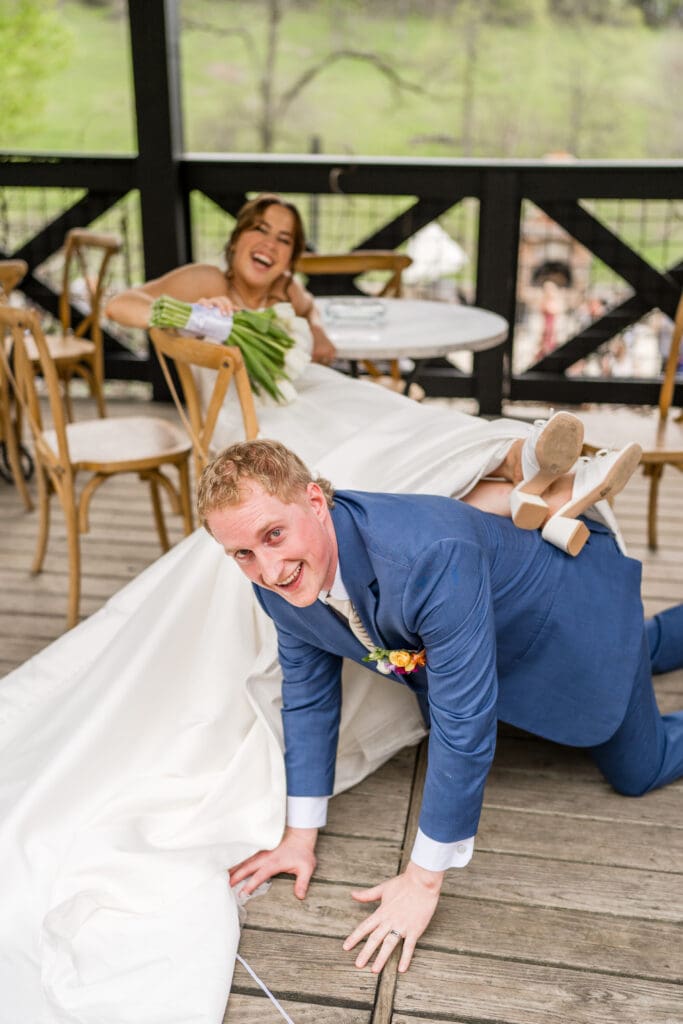 Bride rests feet on top of groom Family photo at at Rivercrest Farms in Dover, Ohio.