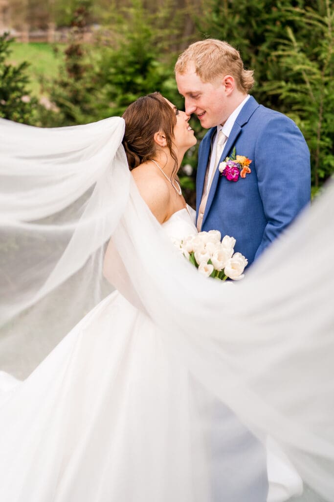 Couple portrait with a cathedral length veil at Rivercrest Farms in Dover, Ohio.