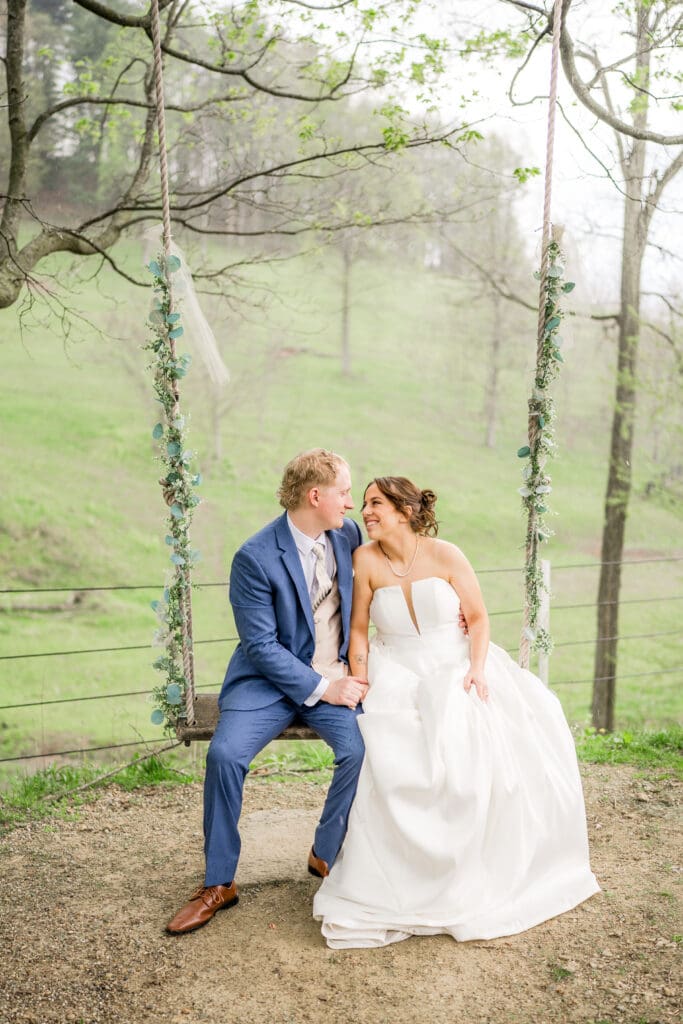The couple sitting on swings at Rivercrest Farms in Dover, Ohio.