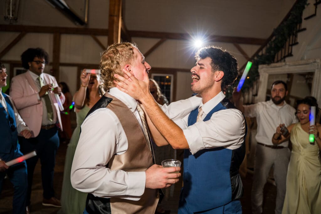 Groom and his groomsman dance on the dance floor.