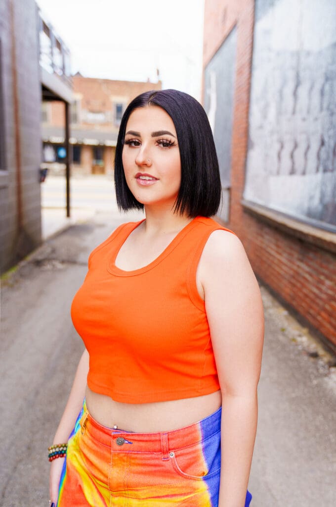 Senior in bright streetwear in Franklinton Columbus, Ohio.