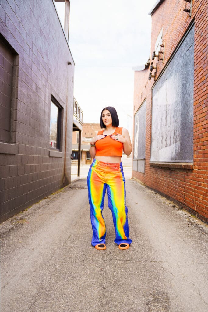 Senior in bright streetwear in Franklinton Columbus, Ohio.
