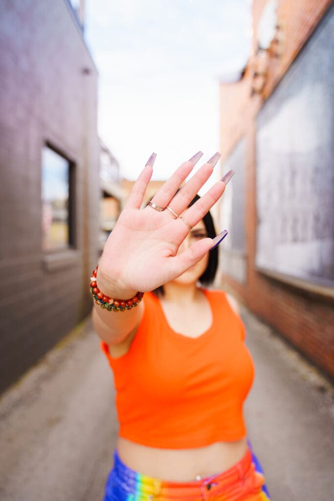 Senior in bright streetwear in Franklinton Columbus, Ohio.