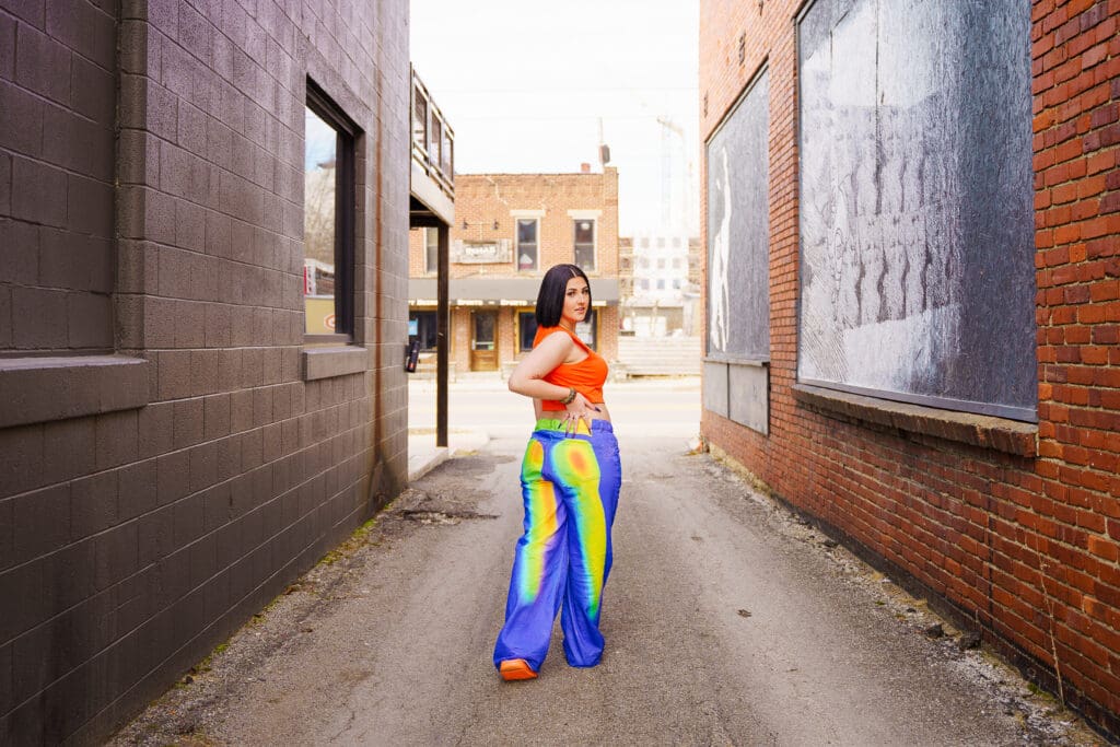 Senior in bright streetwear in Franklinton Columbus, Ohio.