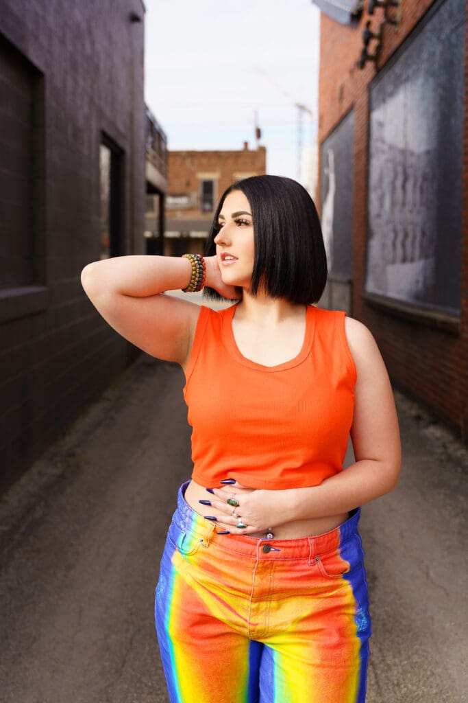 Senior in bright streetwear in Franklinton Columbus, Ohio.