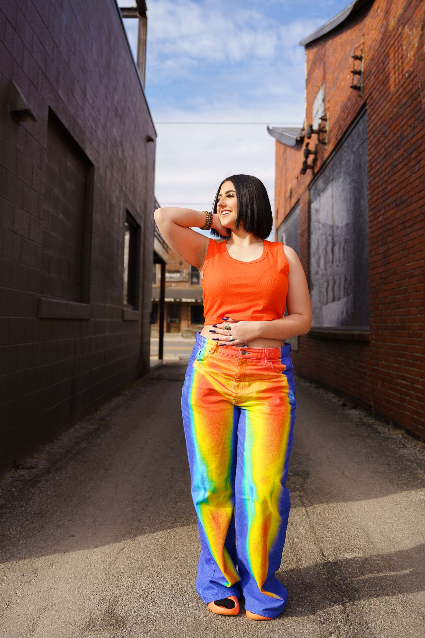 Senior in bright streetwear in Franklinton Columbus, Ohio.