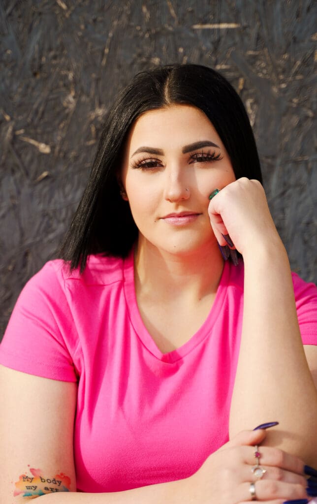 Senior in a bright pink outfit in Franklinton Columbus, Ohio.