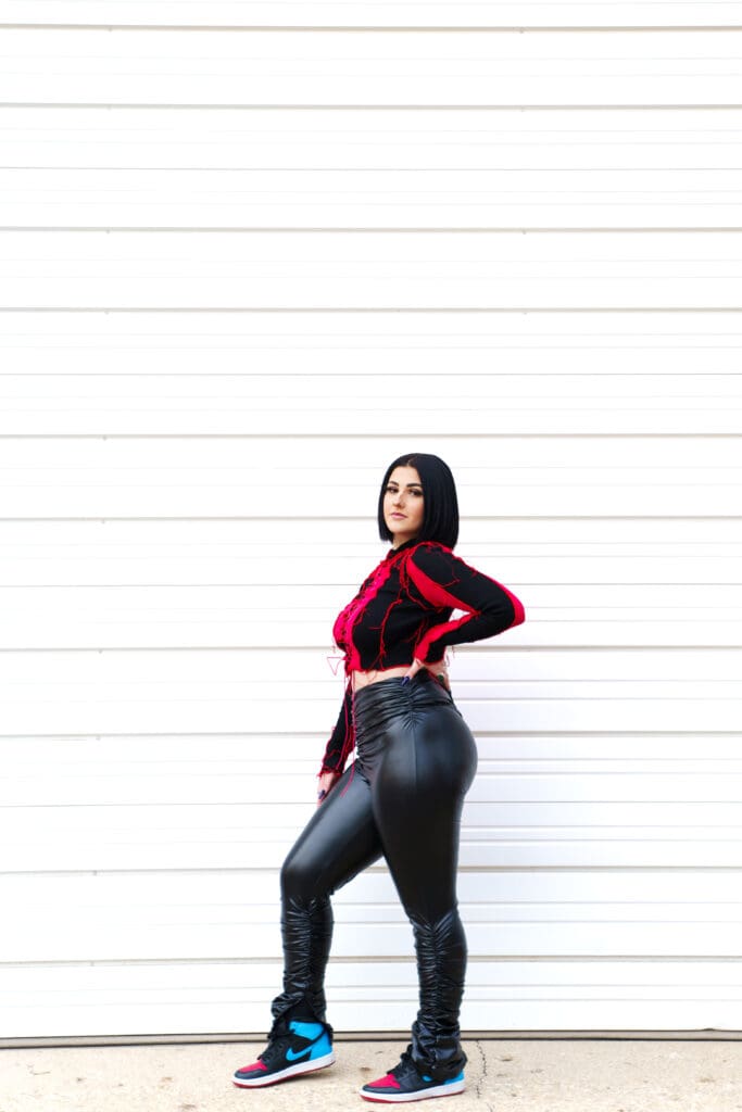 Senior in streetwear with a plain urban background in Columbus, Ohio.