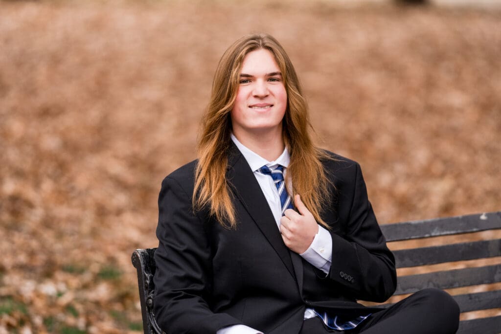 Senior boy in a suit during Fall at Goodale Park in Columbus, Ohio.