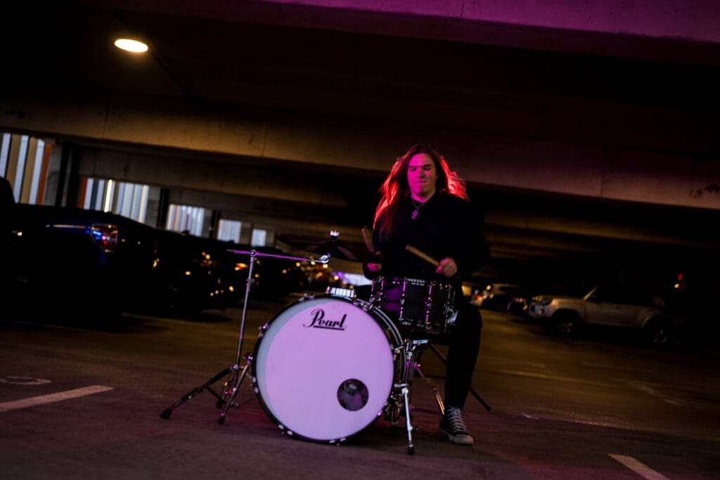 Senior playing his drum set in a parking garage in Columbus, Ohio.