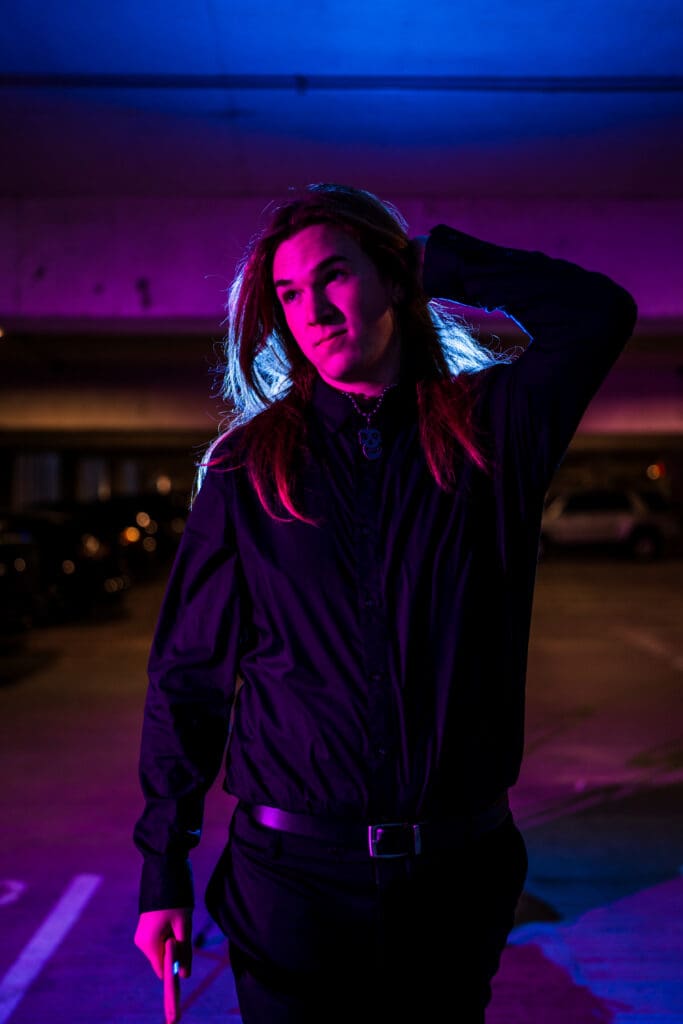 Senior with creative colored lighting in a parking garage in Columbus, Ohio.