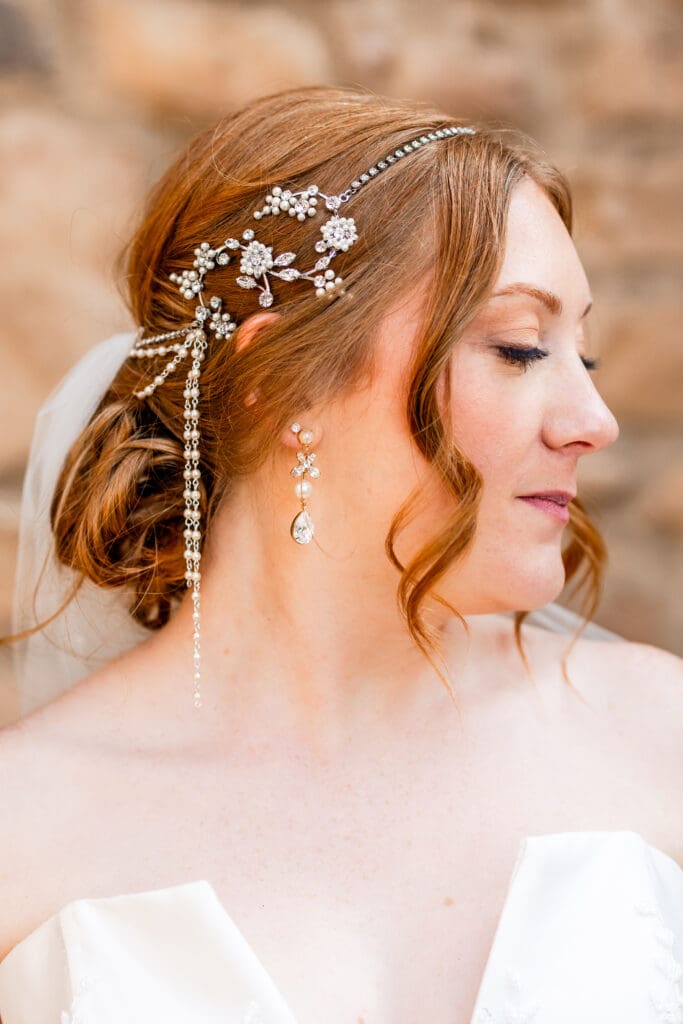 The bride's unique, beautiful hair piece and earring details.