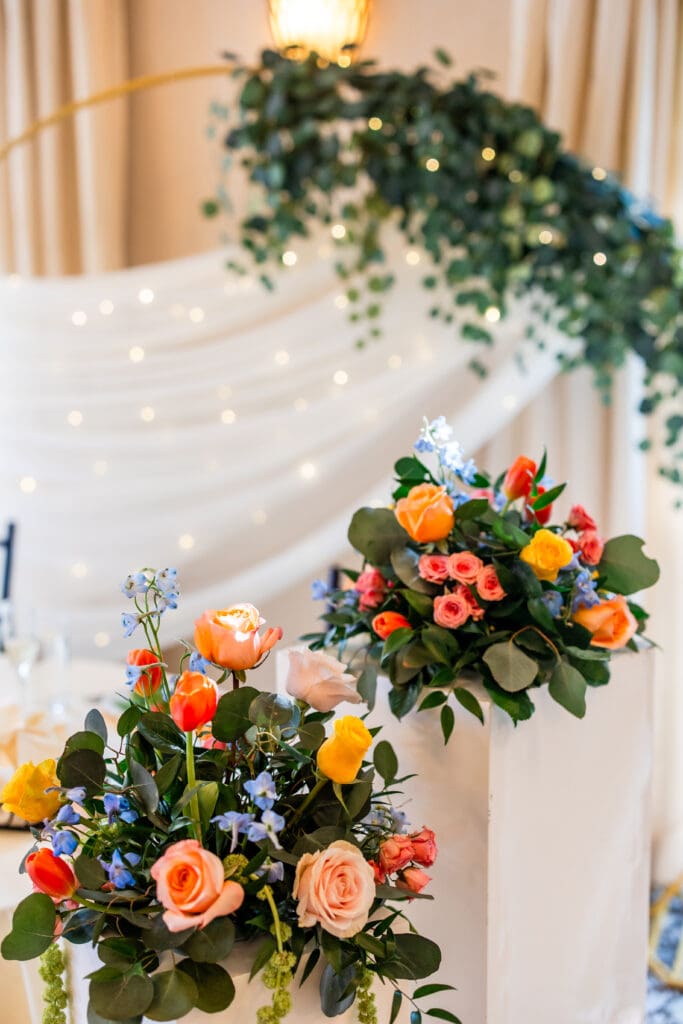 Colorful florals with circular arch in the background.