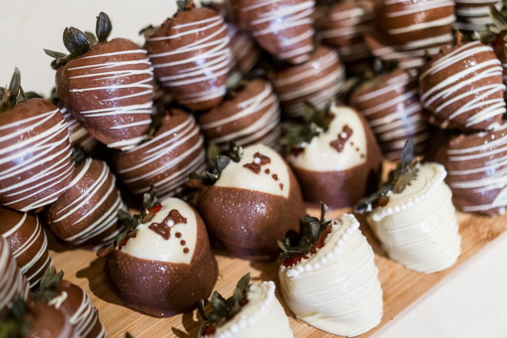 Chocolate covered strawberries decorated to look like suits and dresses.