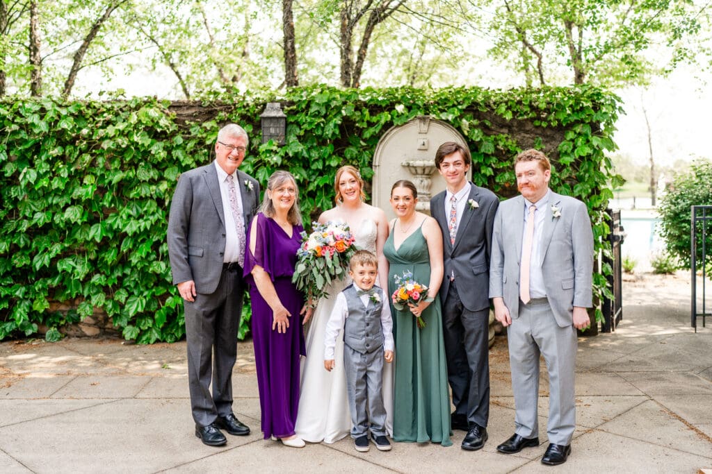 The bride and her family pose for a formal family photo.
