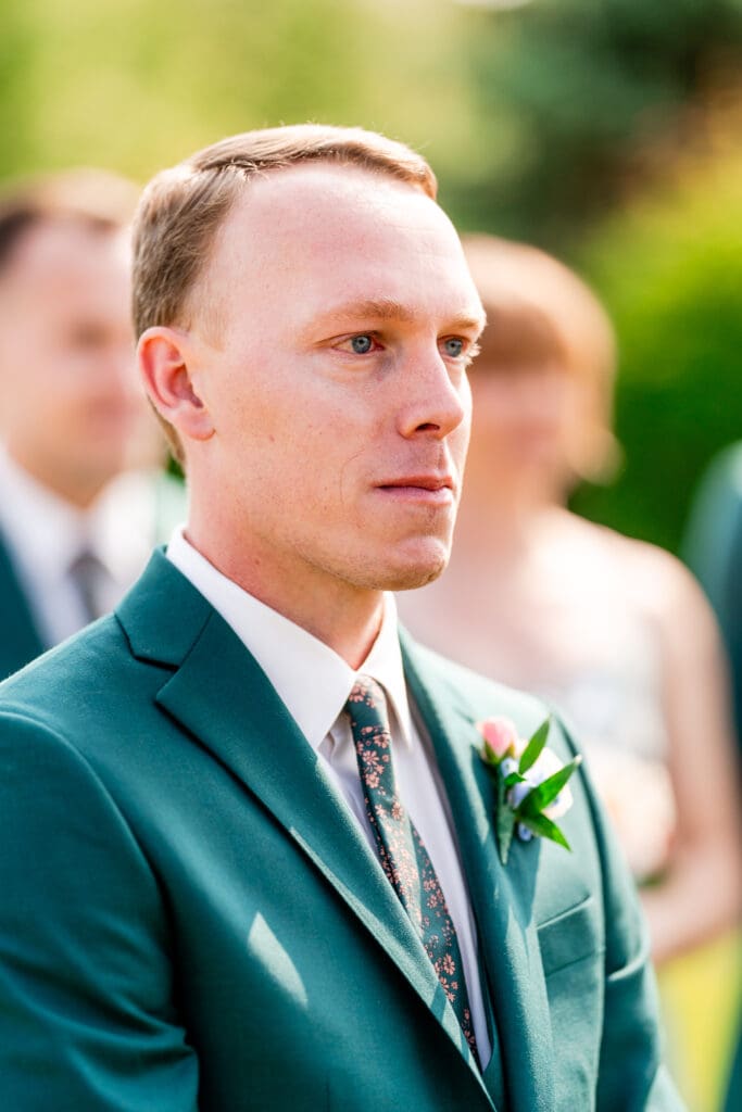 The groom's emotional reaction to seeing his bride walk down the aisle.