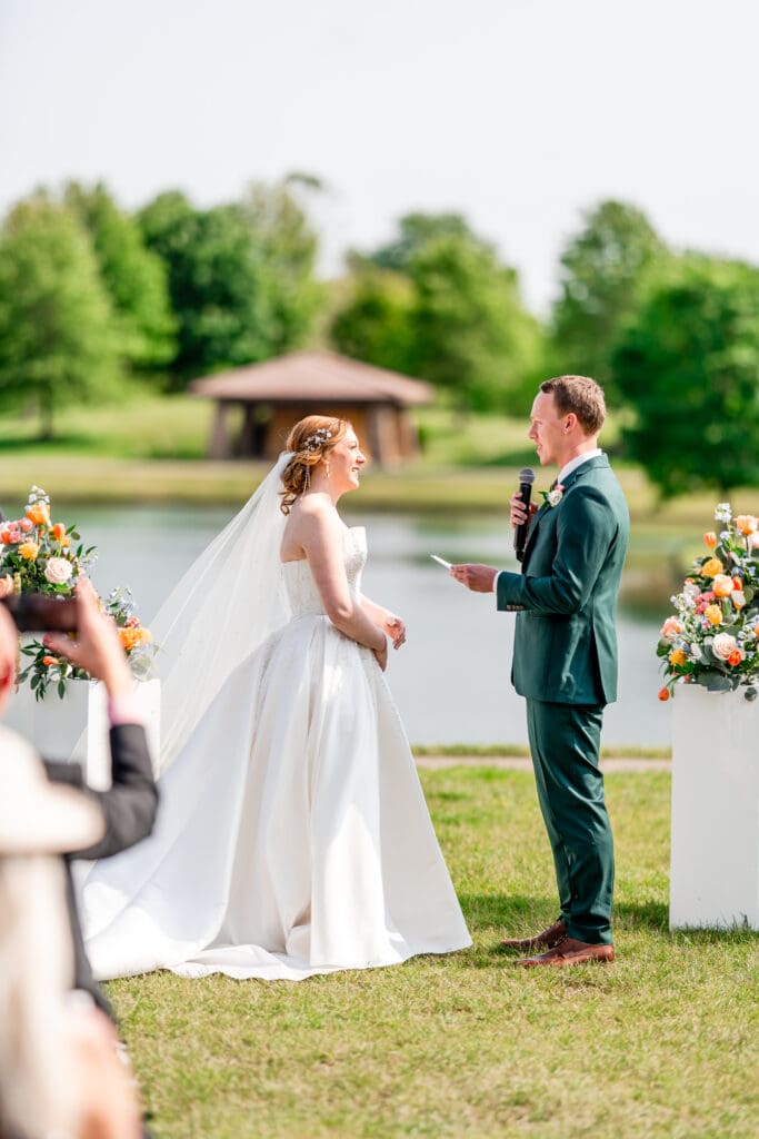 The groom reads his vows at their outdoor ceremony at the Club at Corazon.