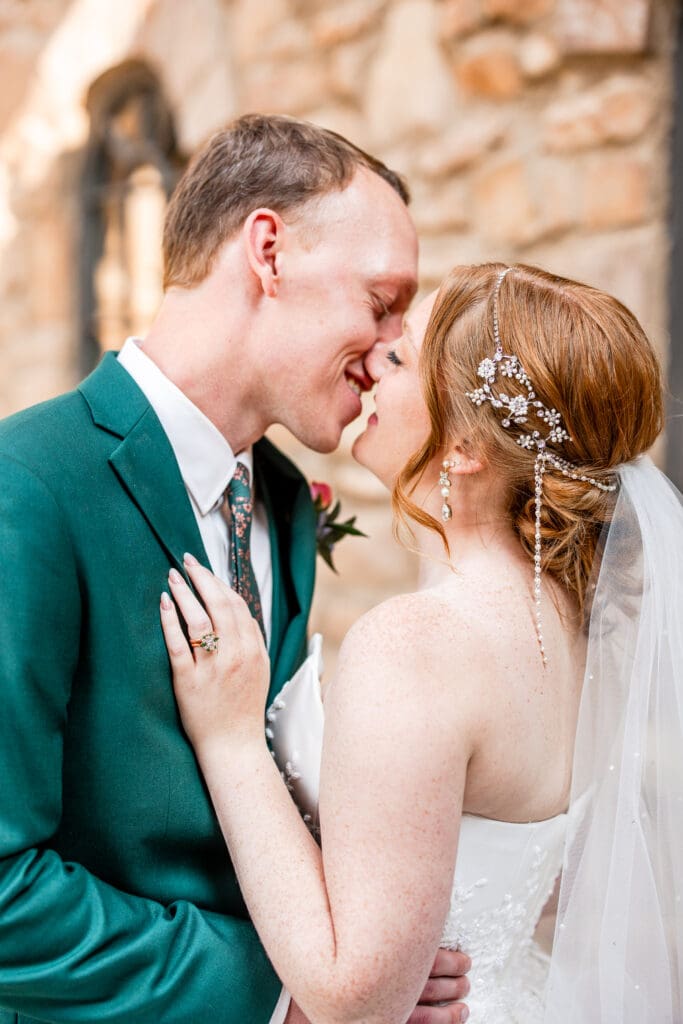 The bride and groom smile close to each other.