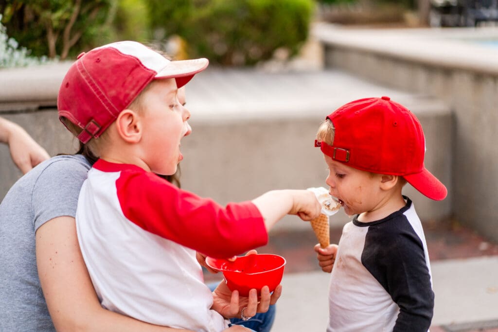 Big brother feeds his little brother ice cream at Johnson's Ice Cream in Canal Winchester, Ohio.