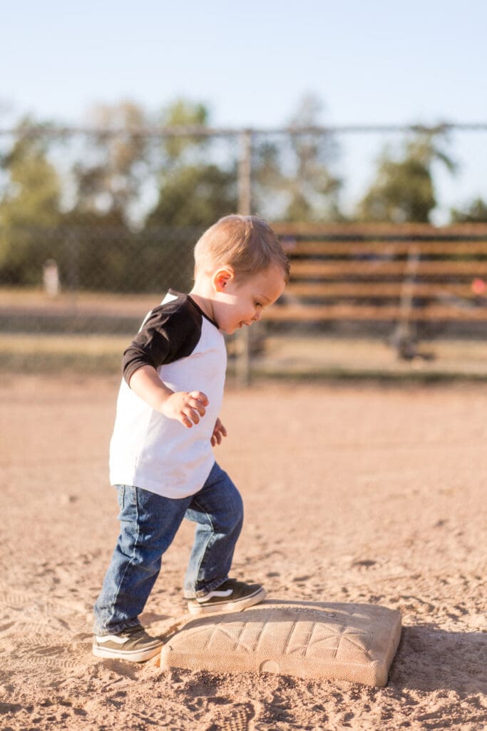 Little boy steps on a base on a baseball field in Canal Winchester, Ohio.