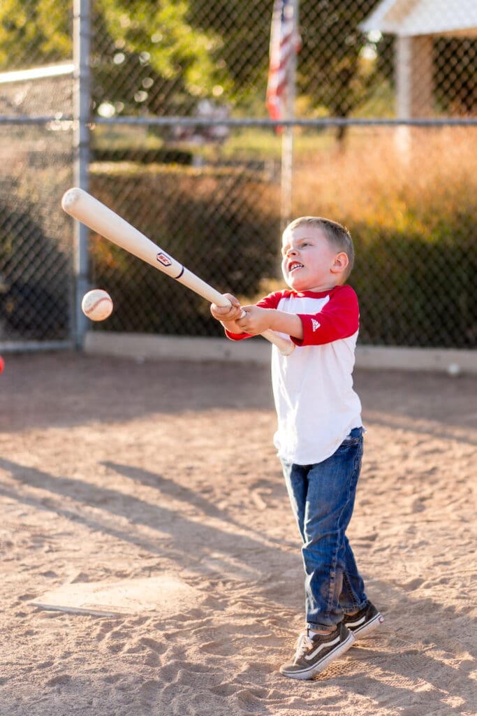 Little boy hits a baseball with a bat in Canal Winchester, Ohio.