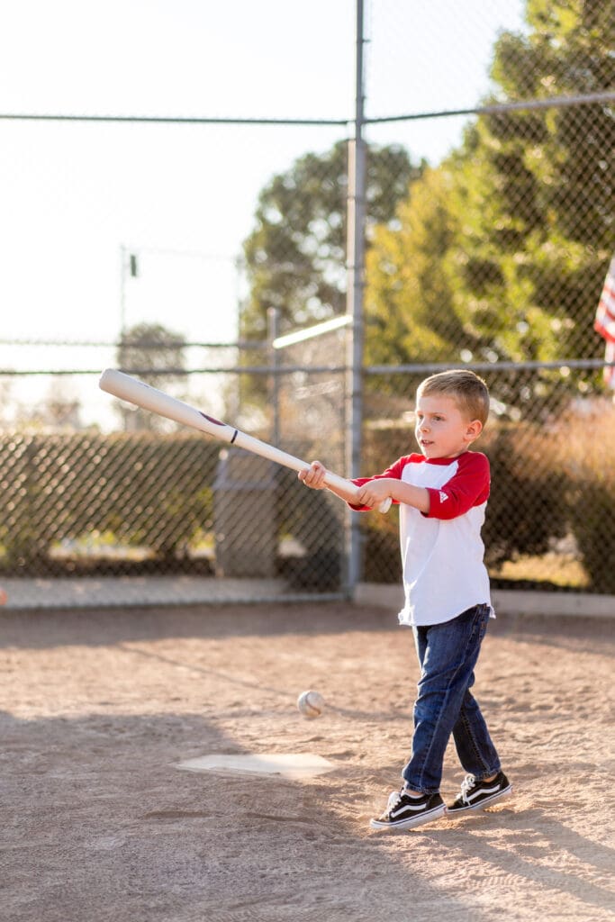 Little boy swinging a bat on a baseball field in Canal Winchester, Ohio.