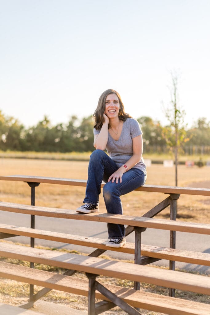 The mother sits in the bleachers at a baseball field in Canal Winchester, Ohio.