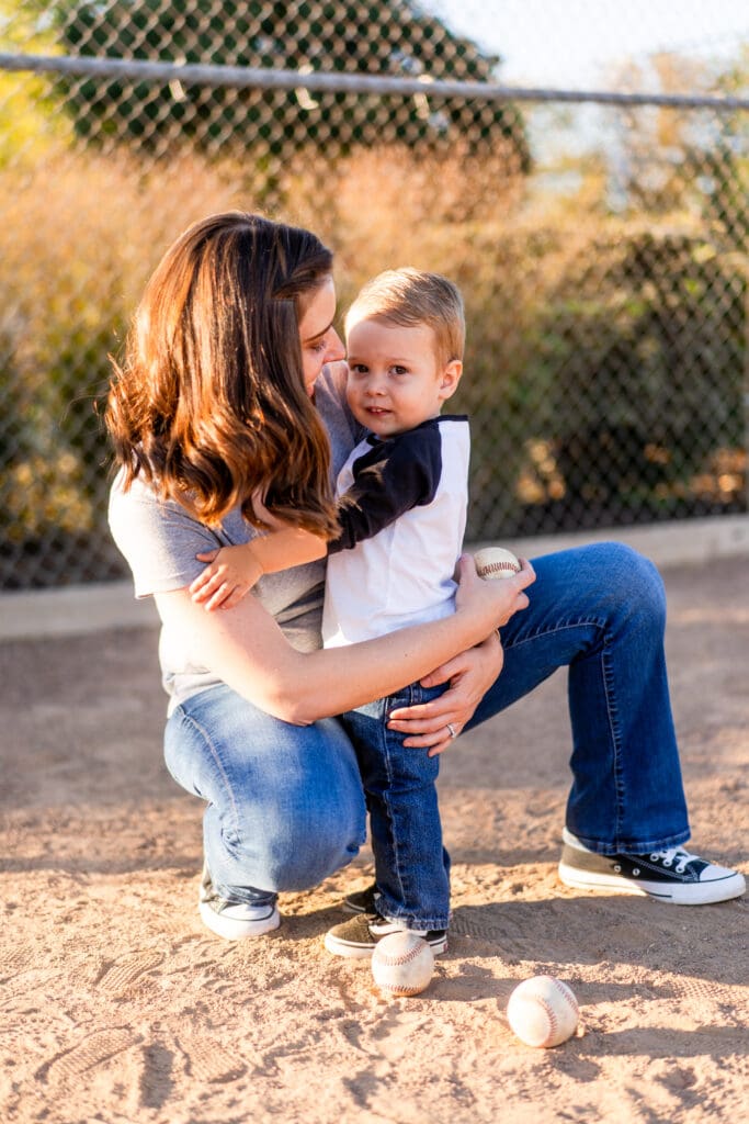 Little boy and his mom hugging baseball field in Canal Winchester, Ohio.
