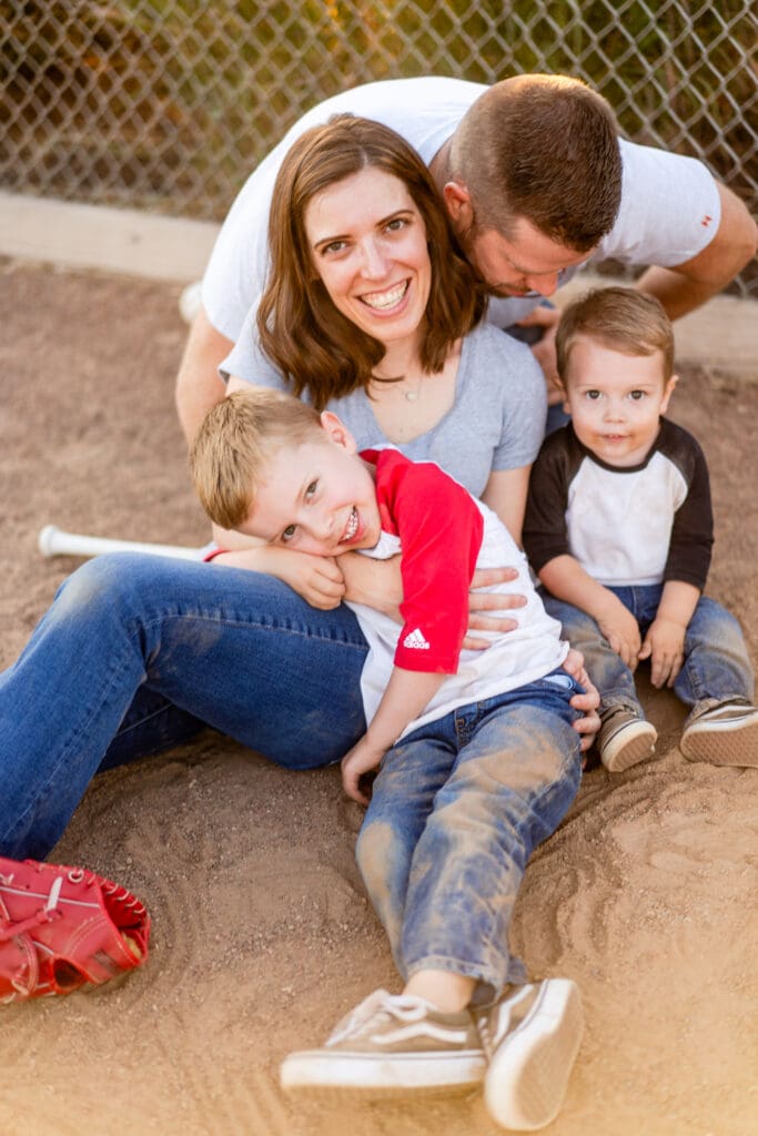 Family lays together for a photo on a baseball field in Canal Winchester, Ohio.
