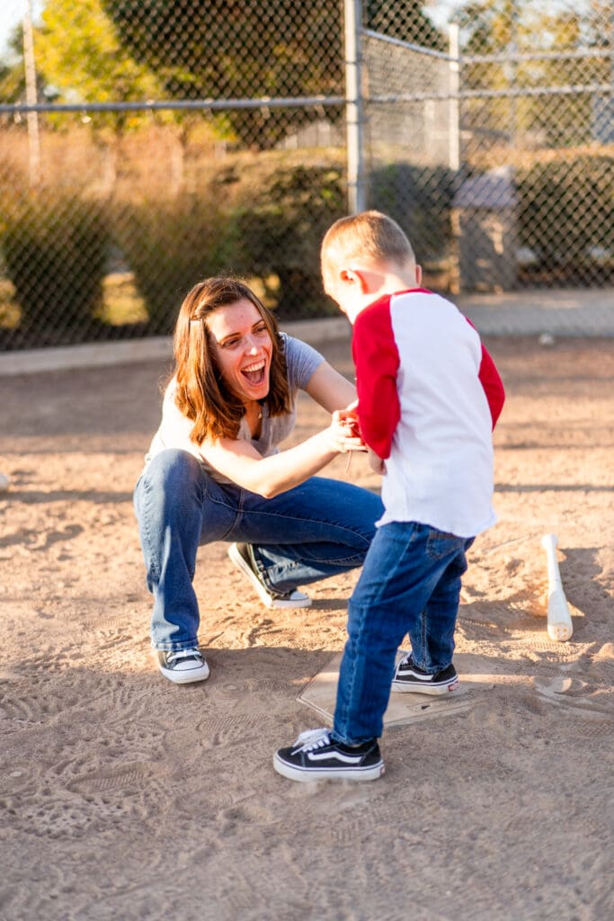 Mother and son play on a baseball field in Canal Winchester, Ohio.