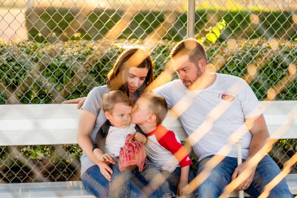 Family sits in the dugout together in Canal Winchester, Ohio.