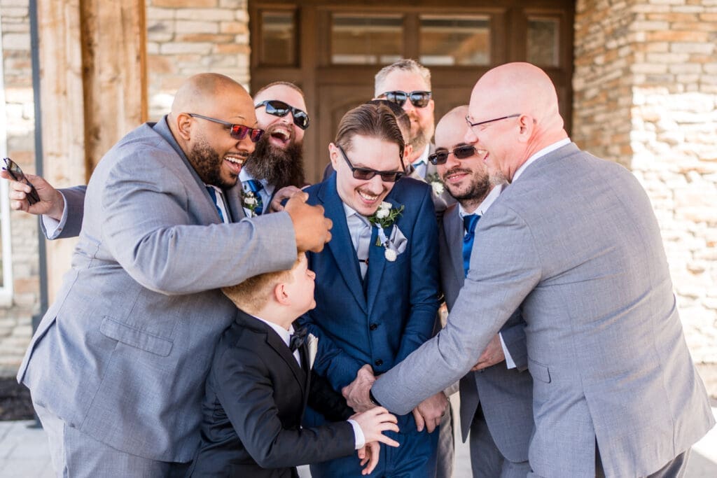 Groomsmen tackle the groom at the Estate at New Albany