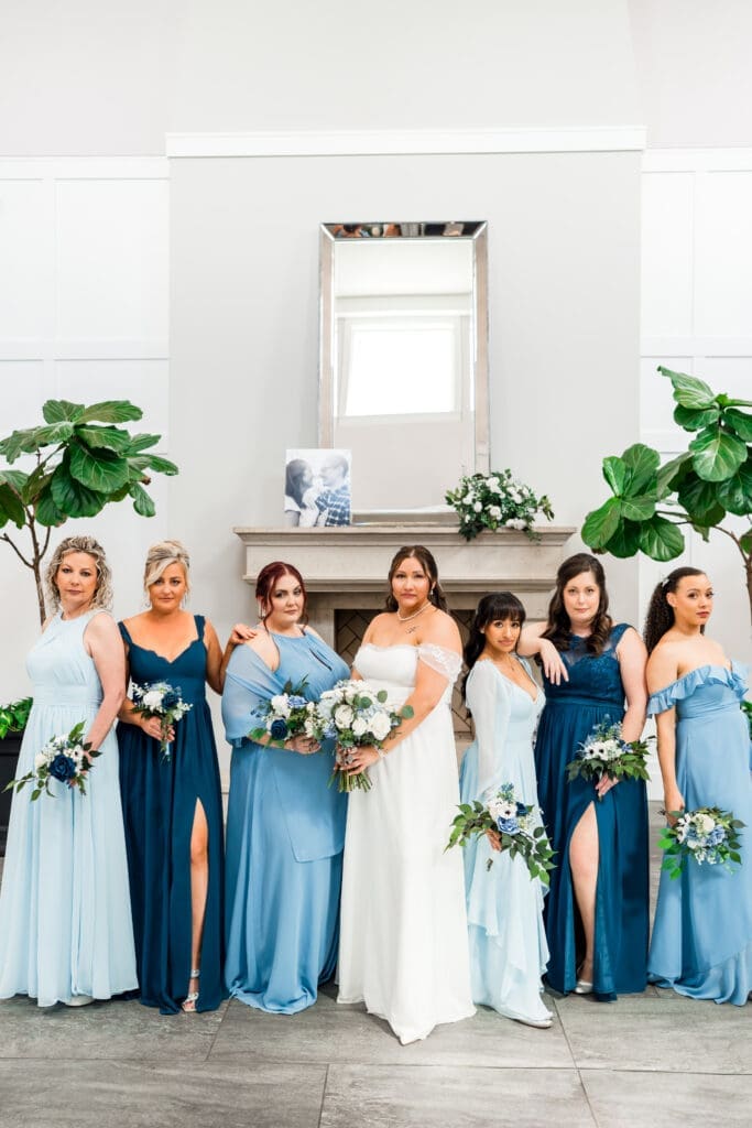 The bride and her bridesmaids do an editorial pose at the Estate at New Albany