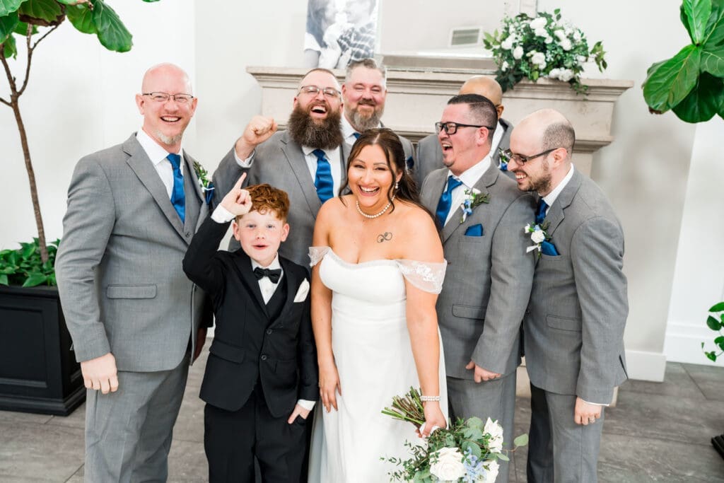 The bride and the groomsmen laughing at the Estate at New Albany