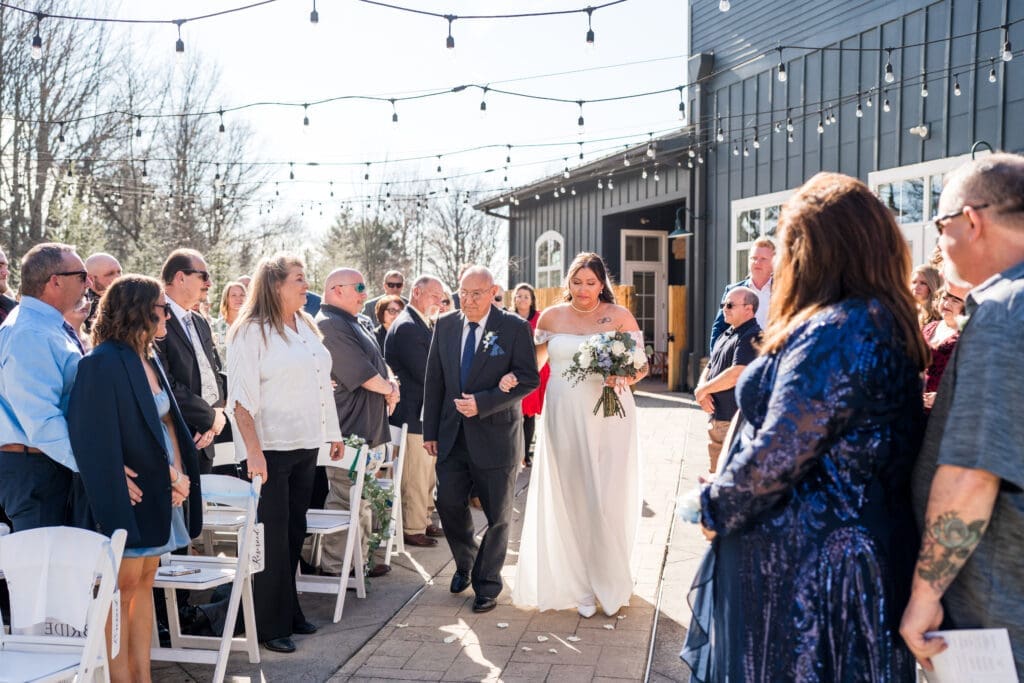 The bride and her grandpa walk down the aisle.