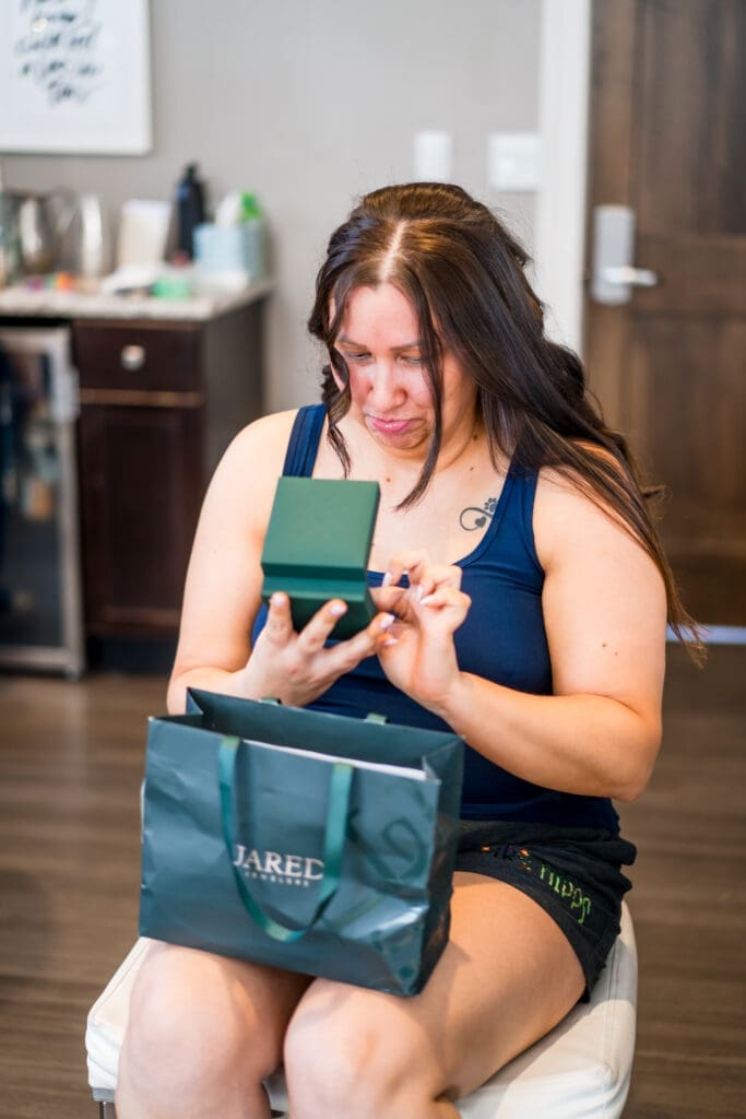 Bride reacts to her gift from her groom while getting ready.