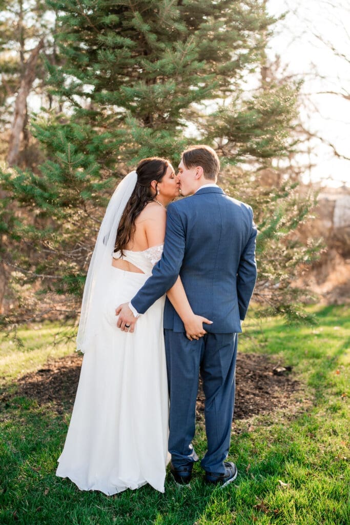 Bride and groom grab each others' butts during their portraits at the Estate at New Albany