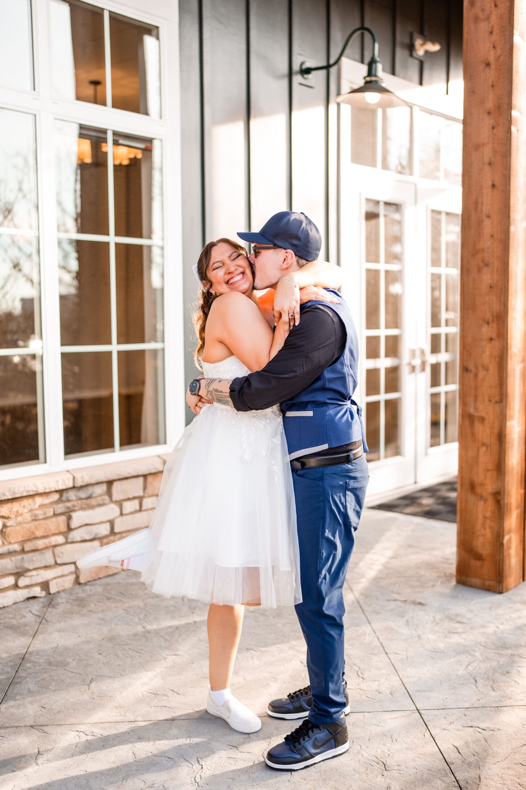 Groom kisses the bride's cheek during their couple portraits at the Estate at New Albany