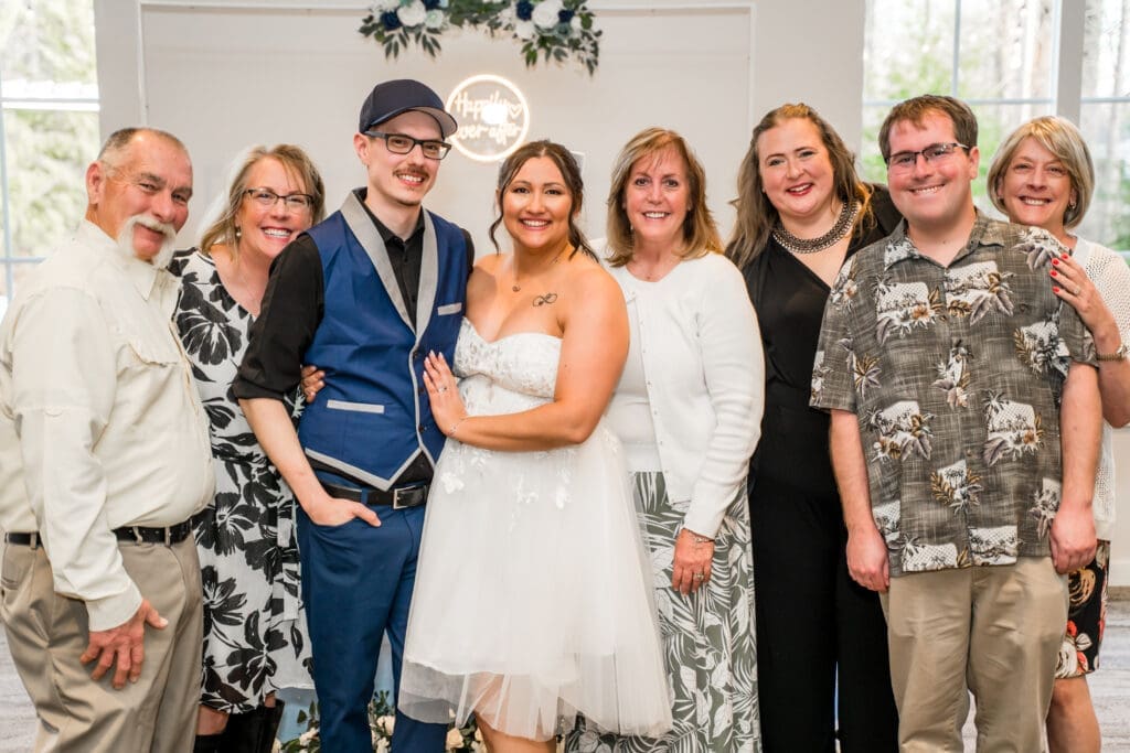 Bride and groom pose with their guests