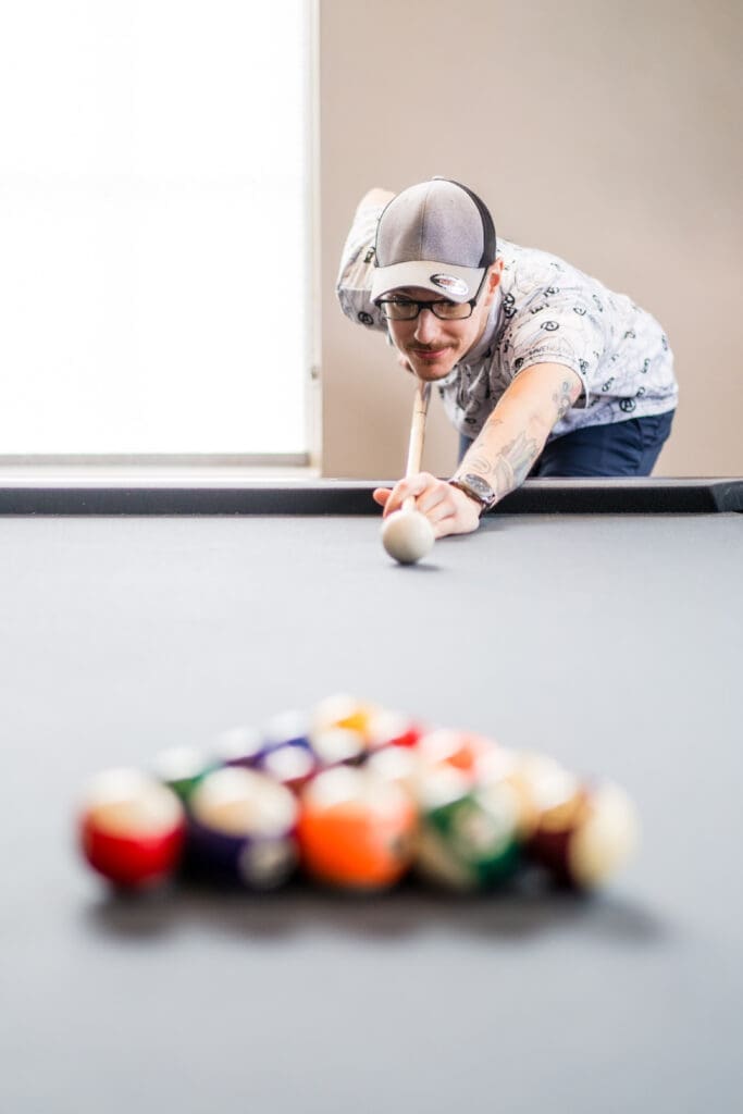 Groom plays pool at the Estate at New Albany