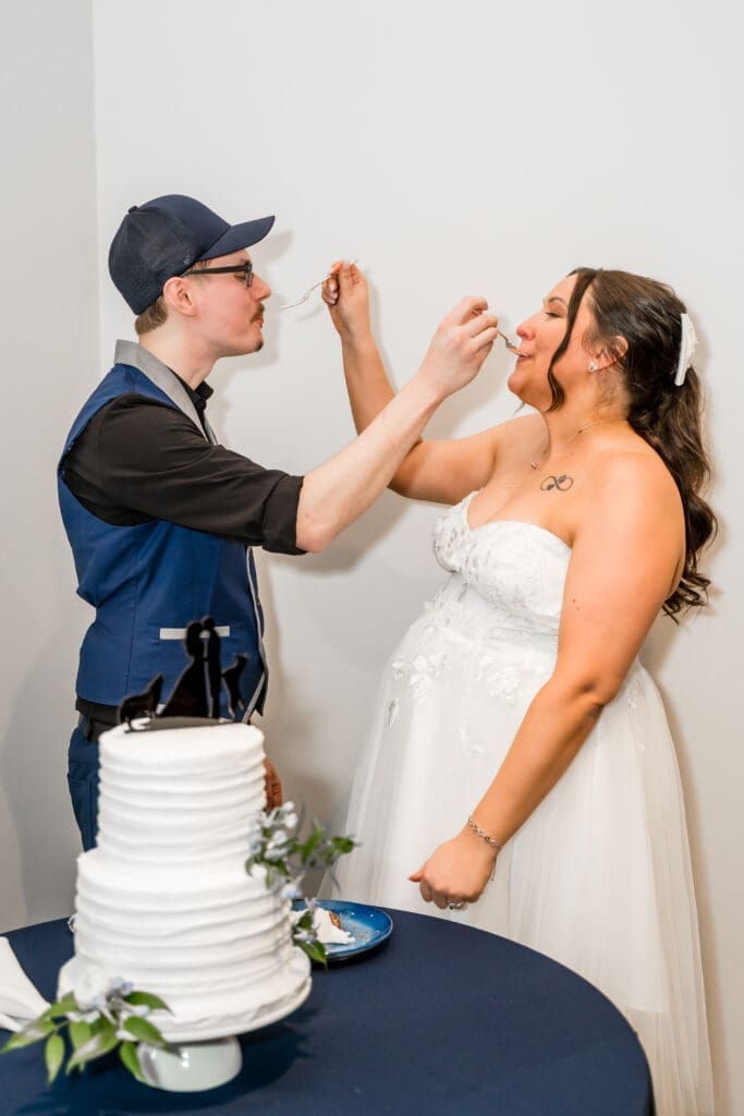 The bride and groom feed each other cake at the Estate at New Albany