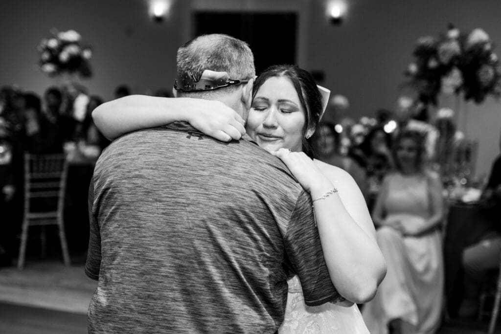 The bride cries as she shares a dance with her new father in law at the Estate at New Albany