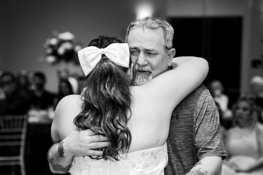 The bride's uncle cries as he shares a dance with is new daughter in law at the Estate at New Albany