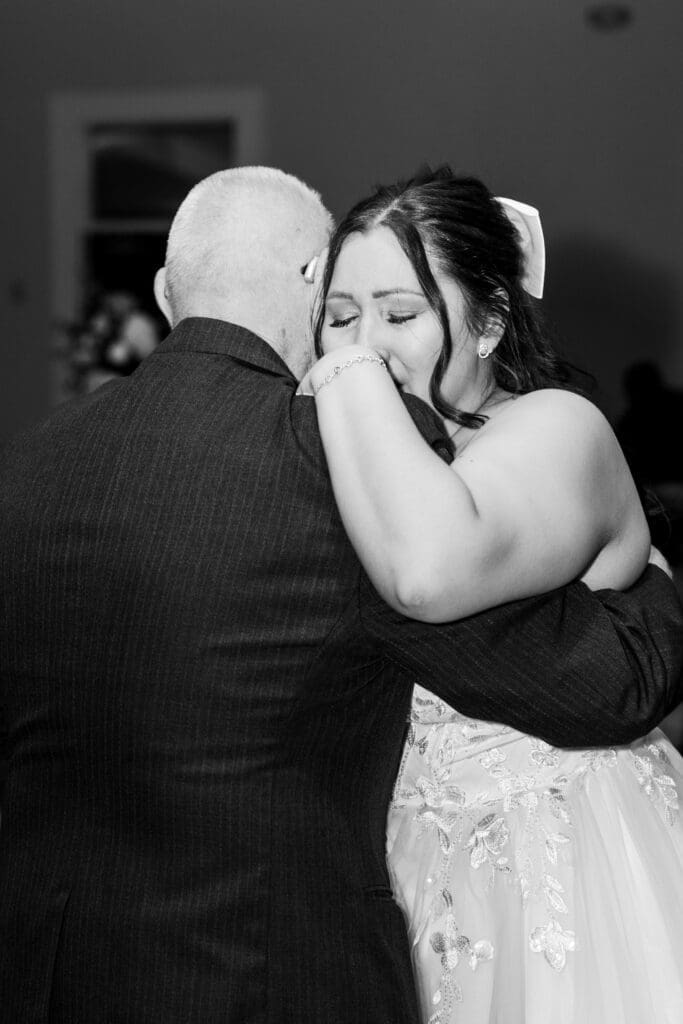 The bride cries as she shares a dance with her grandpa at the Estate at New Albany